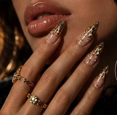 Nude and gold stiletto nails with crystal detailing